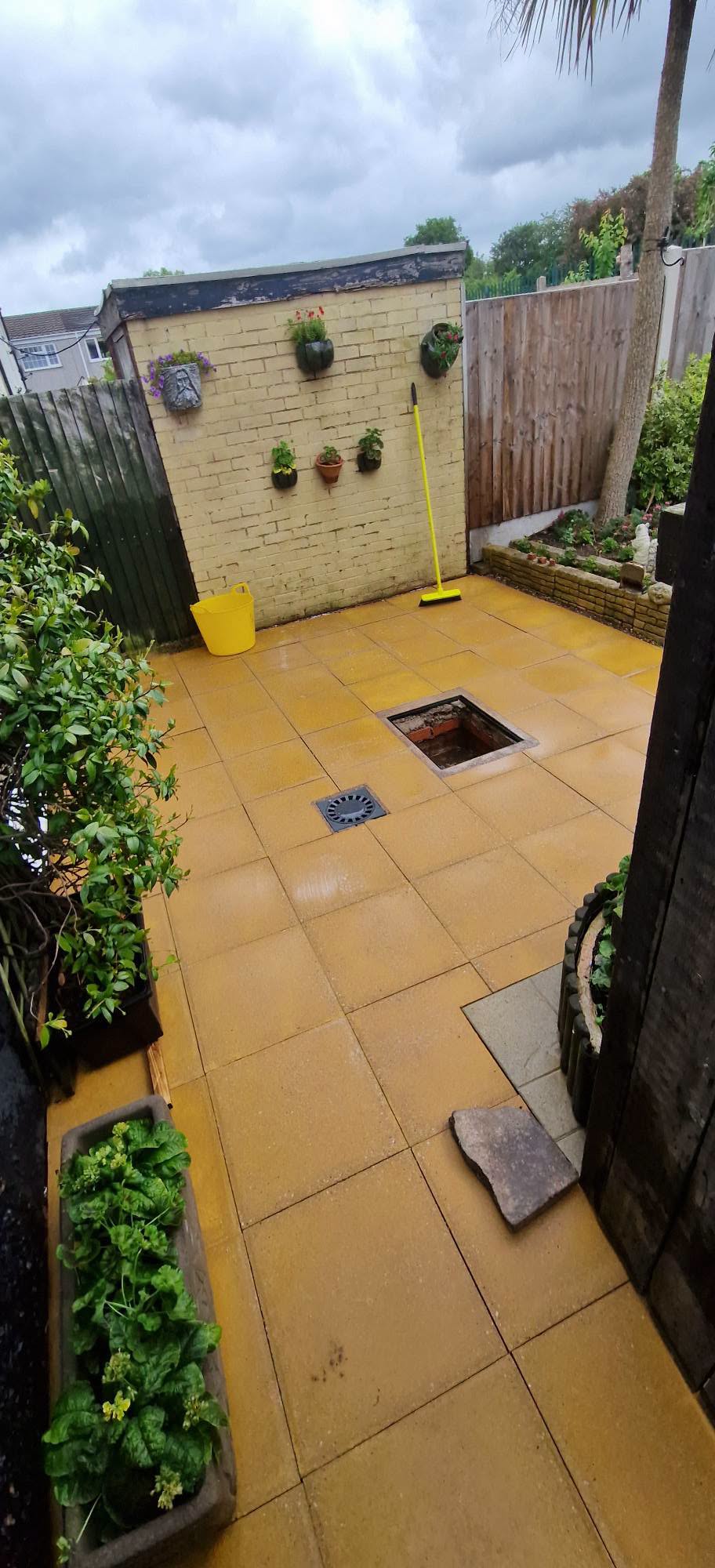 The same courtyard patio slabs restored to clean buff stone after pressure washing