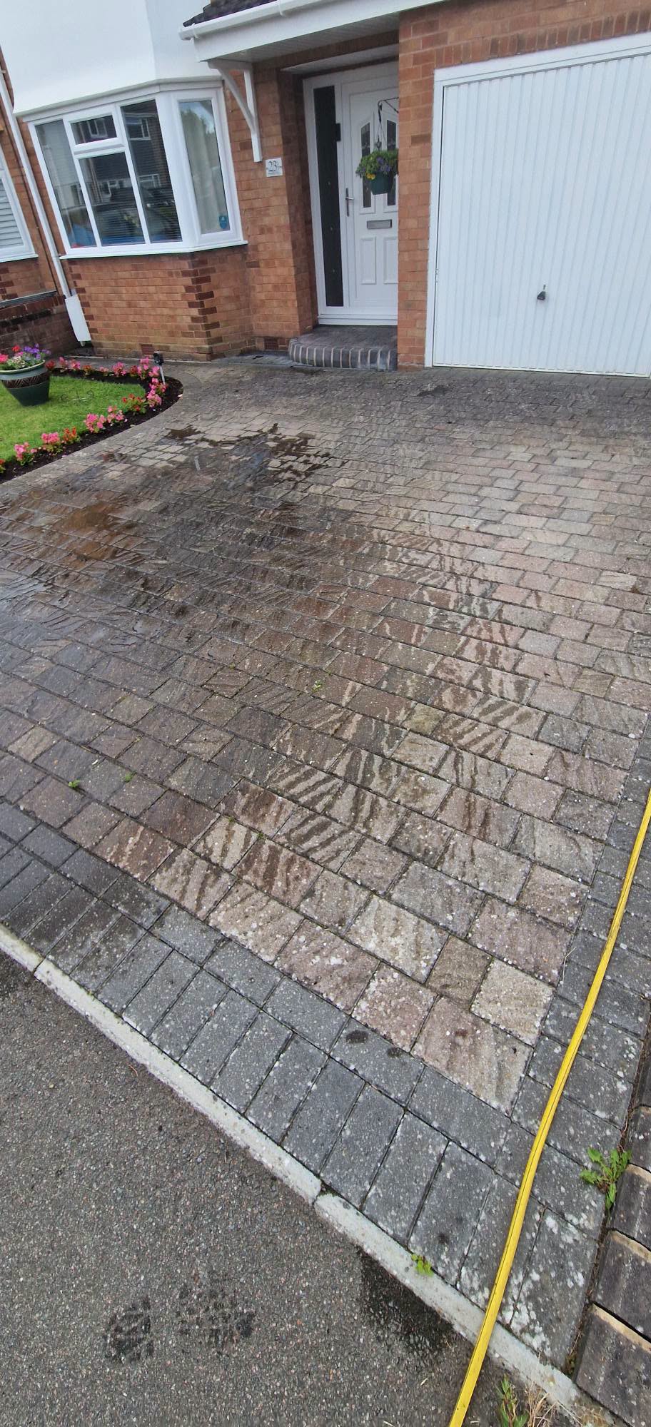 Block paved driveway being pressure washed clean in Redditch, Worcestershire