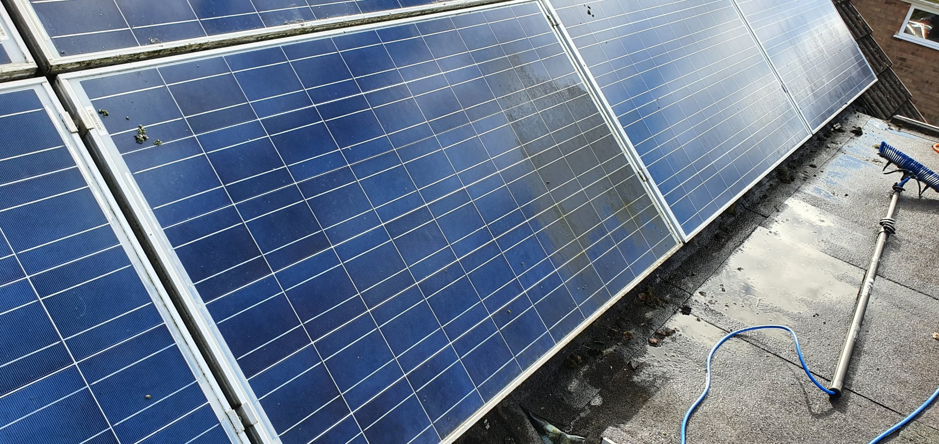 Solar panel cleaning removing dirt and algae from roof-mounted panels in Redditch, Worcestershire